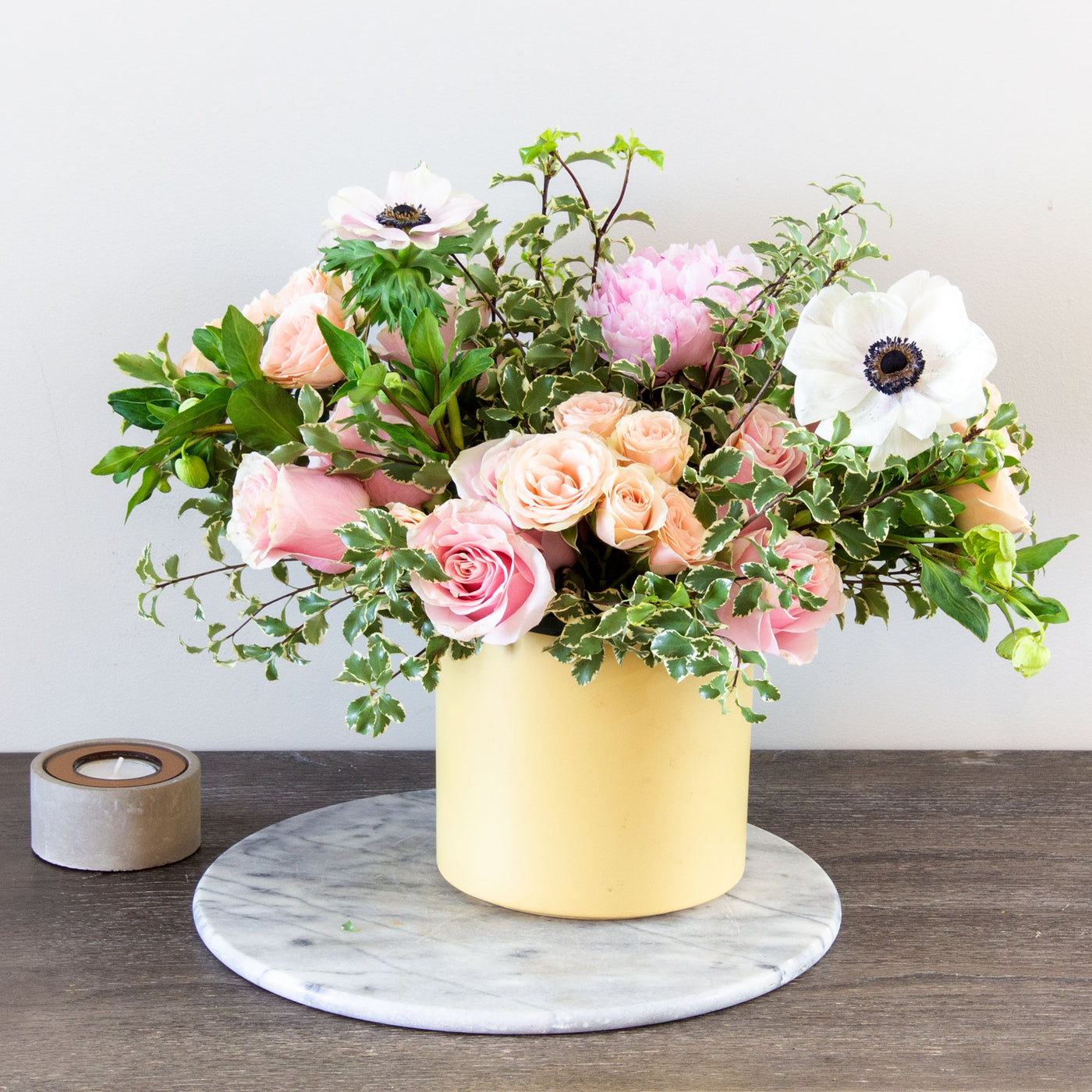 Our Portrait of a Lady bouquet delivers all the sweetness of spring. Beverly Hills Florist presents our wonderful arrangement for same day delivery ! A garden-fresh gathering of peach and pink Roses and Anemones in yellow container accented by wispy greens. It’s a gift full of warmth and happiness.