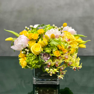 Beverly Hills Florist presents Mellow Yellow for same day delivery! Includes, Yellow Roses, White and light pink Peonies, Green Hydrangeas, Baby  Orchids, cabbage, yellow Tulips and seasonal berries 